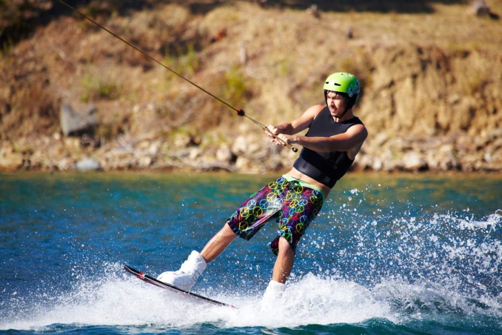 Young wakeboarder sliding out on his back foot - copyspace